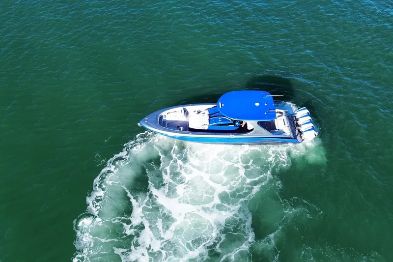 Slide: The Image of Aerial view of 2023 Mystic Powerboats M3800 cruising on open water. - 5