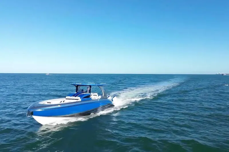 Slide: The Image of 2023 Mystic Powerboats M3800 cruising on open blue ocean under clear sky. - 7