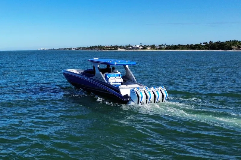 Slide: The Image of 2023 Mystic Powerboats M3800 cruising on open water, showcasing sleek design and powerful engines. - 8