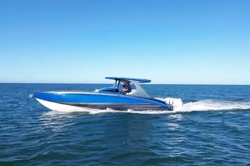 Slide: The Image of 2023 Mystic Powerboats M3800 cruising on open water, showcasing sleek design and performance. - 9
