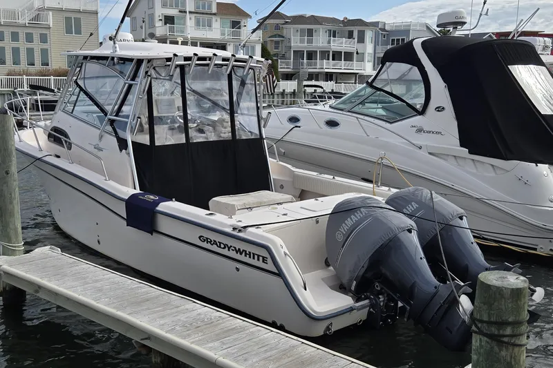 Slide: The Image of 2005 Grady-White Marlin 300 boat docked with twin Yamaha engines. - 0