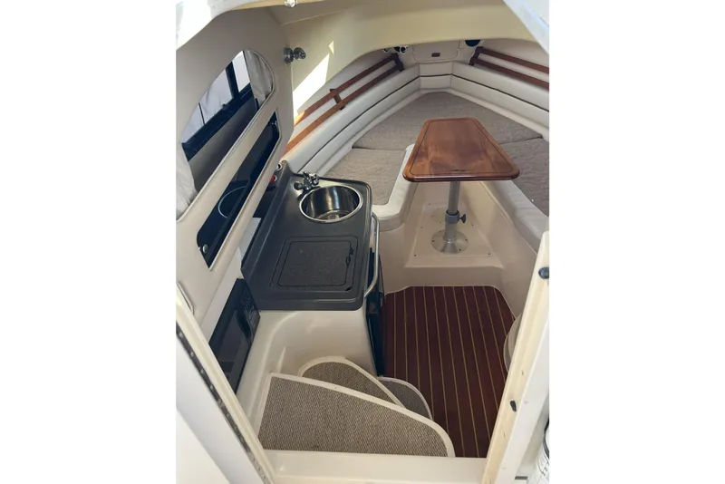 Slide: The Image of 2005 Grady-White Marlin 300 cabin interior with kitchenette and seating area. - 1