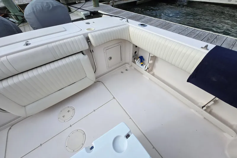 Slide: The Image of 2005 Grady-White Marlin 300 boat interior with white cushioned seating and storage compartments. - 11