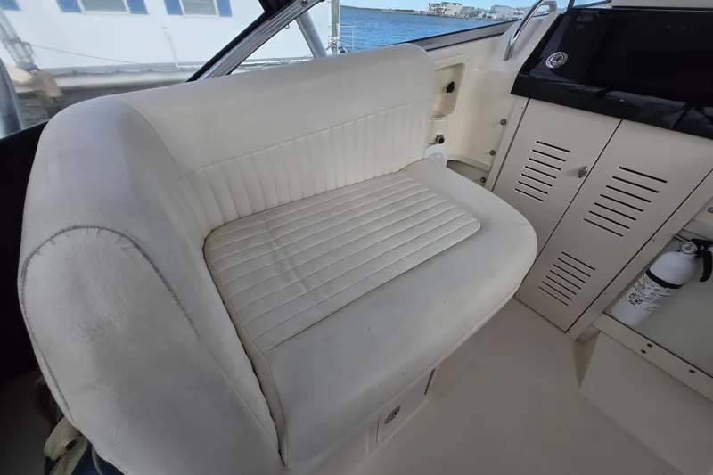 Slide: The Image of 2005 Grady-White Marlin 300 interior with white seating and storage compartments. - 16
