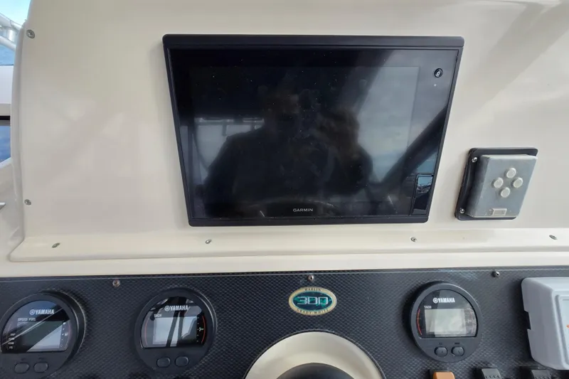 Slide: The Image of Dashboard of 2005 Grady-White Marlin 300 with Garmin display and Yamaha gauges. - 18