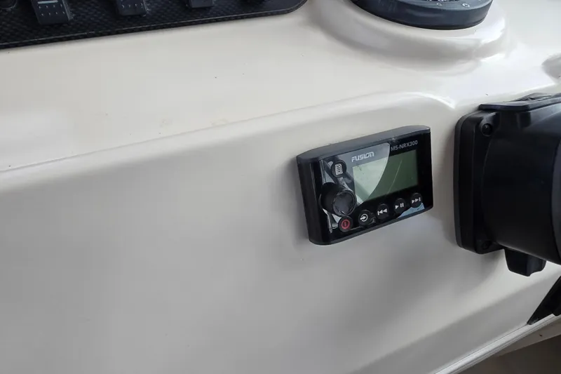 Slide: The Image of Control panel of a 2005 Grady-White Marlin 300 boat with Fusion MS-NRX300. - 19