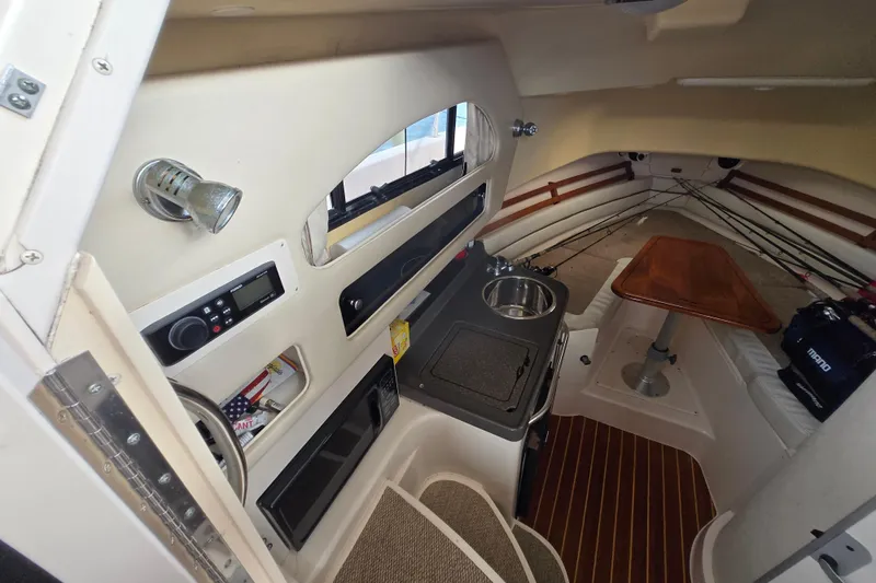 Slide: The Image of 2005 Grady-White Marlin 300 cabin interior with kitchenette and seating area. - 24