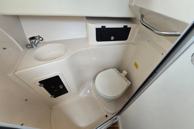 Slide: The Image of Compact bathroom in 2005 Grady-White Marlin 300 boat with toilet and sink. - 25