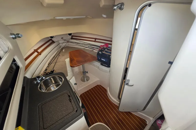 Slide: The Image of 2005 Grady-White Marlin 300 cabin interior with kitchenette and seating area. - 26