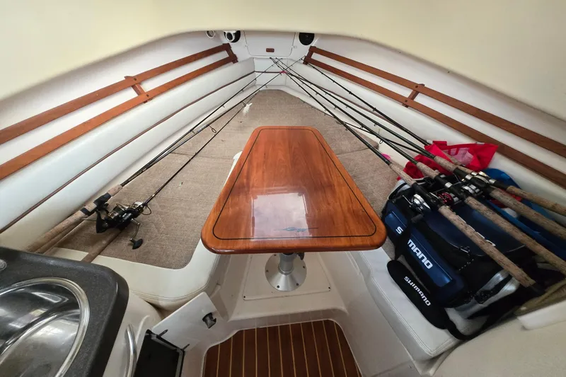 Slide: The Image of Interior of 2005 Grady-White Marlin 300 boat with fishing rods and wooden table. - 28