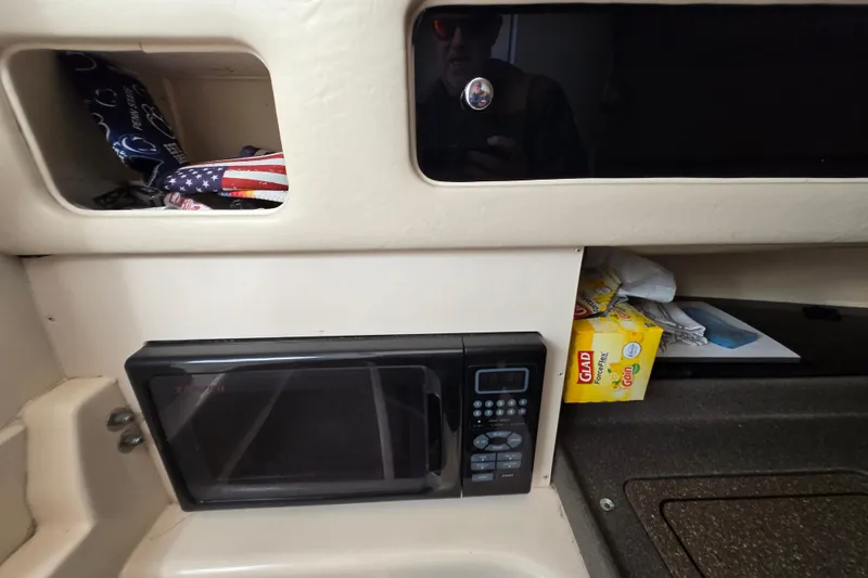 Slide: The Image of 2005 Grady-White Marlin 300 interior with microwave and storage compartments. - 30