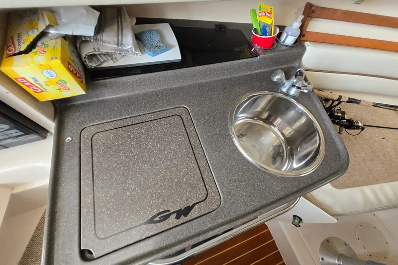 Slide: The Image of 2005 Grady-White Marlin 300 boat kitchenette with sink and countertop essentials. - 32