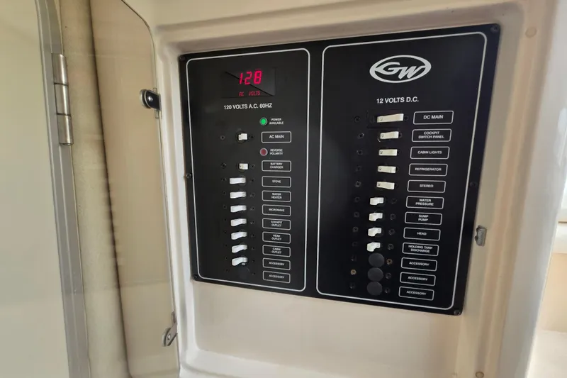 Slide: The Image of Electrical panel of a 2005 Grady-White Marlin 300 boat, showing AC and DC switches. - 33