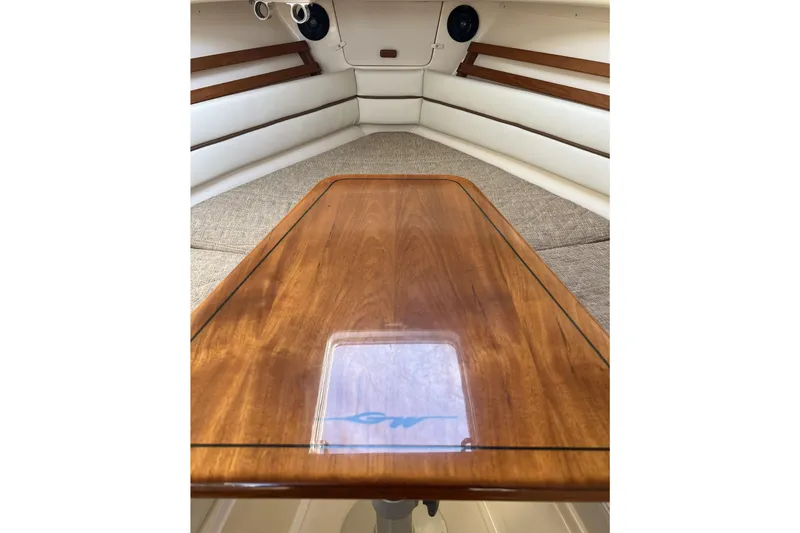 Slide: The Image of Interior of 2005 Grady-White Marlin 300 boat with wooden table and cushioned seating. - 39
