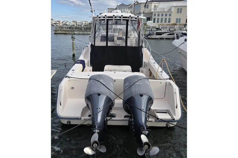 Slide: The Image of 2005 Grady-White Marlin 300 boat with dual Yamaha outboard engines docked at marina. - 4