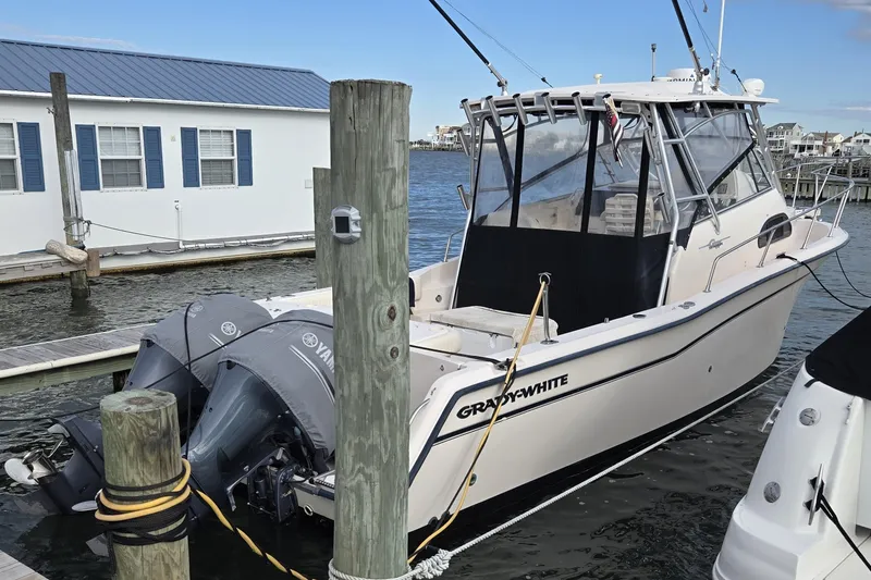 Slide: The Image of 2005 Grady-White Marlin 300 boat docked with twin Yamaha engines. - 5