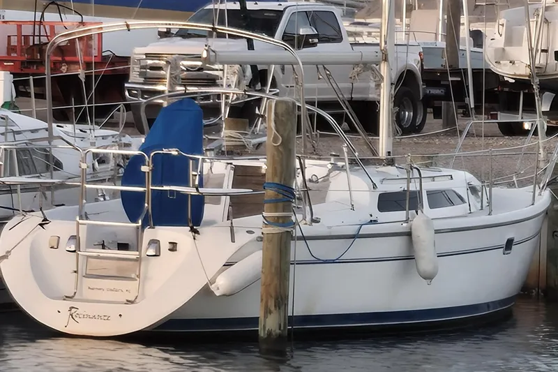 The Image of 1999 Catalina 28 MkII sailboat for sale, covered and docked, with visible contact information. - 0