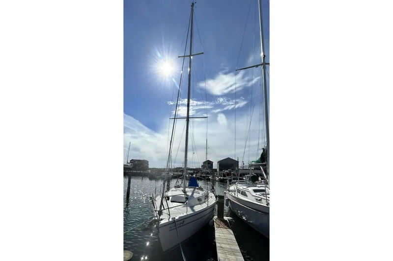 Slide: The Image of Masts of a 1999 Catalina 28 MkII sailboat against a vibrant sunset sky. - 15