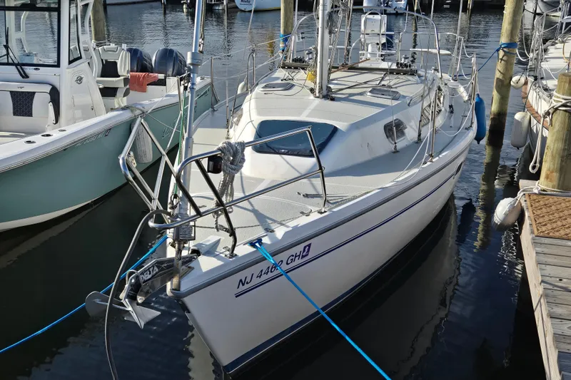 Slide: The Image of 1999 Catalina 28 MkII sailboat docked at marina, calm water, sunset background. - 21