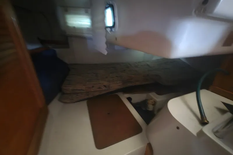 Slide: The Image of Interior cabin of a 1999 Catalina 28 MkII sailboat, featuring a cozy sleeping area. - 26
