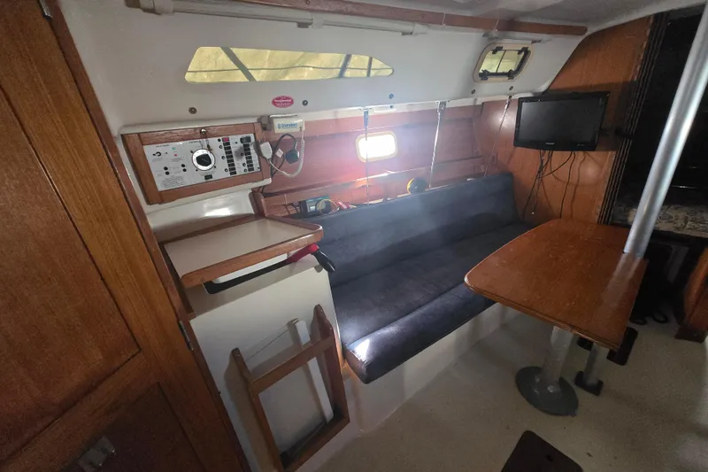 Slide: The Image of Interior of 1999 Catalina 28 MkII sailboat with seating, table, and control panel. - 28