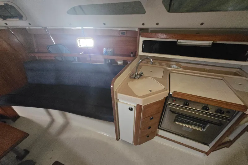 Slide: The Image of Interior of 1999 Catalina 28 MkII sailboat with kitchen and seating area. - 29