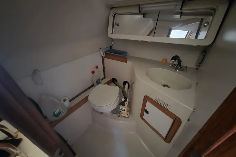 Slide: The Image of 1999 Catalina 28 MkII yacht bathroom with toilet, sink, and mirror. - 31