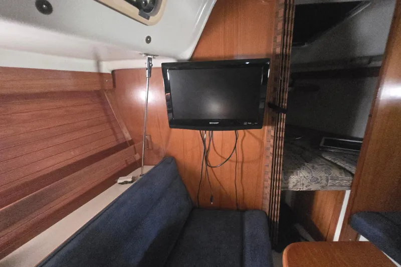 Slide: The Image of Interior of a 1999 Catalina 28 MkII sailboat with TV and seating area. - 32