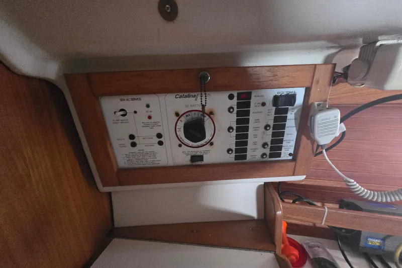 Slide: The Image of Electrical panel of a 1999 Catalina 28 MkII sailboat, featuring switches and controls. - 34