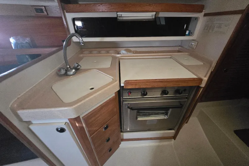 Slide: The Image of Compact kitchen in a 1999 Catalina 28 MkII sailboat with stove and sink. - 35