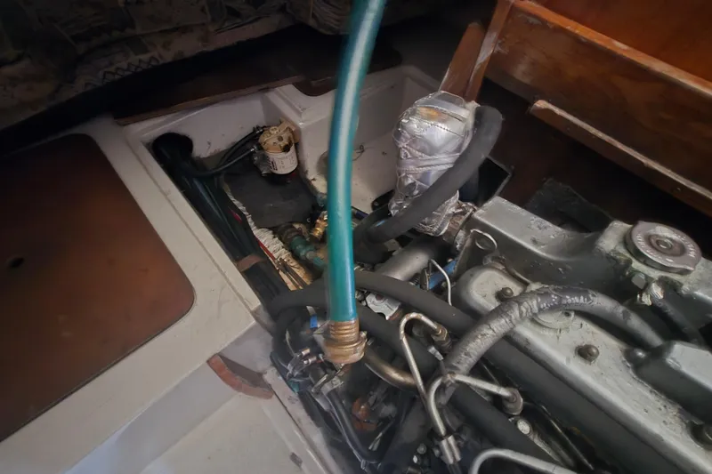 Slide: The Image of Engine compartment of a 1999 Catalina 28 MkII sailboat with visible hoses and components. - 40
