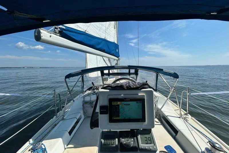 Slide: The Image of Interior of 1999 Catalina 28 MkII sailboat with blue seating and wooden table. - 5
