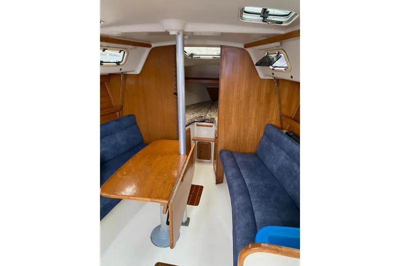 Slide: The Image of 1999 Catalina 28 MkII sailboat docked at marina during sunset, surrounded by other boats. - 6