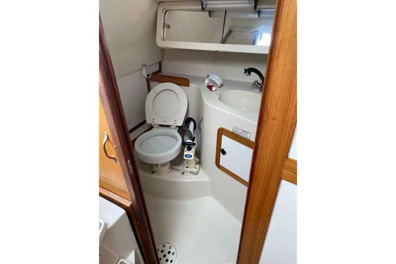 Slide: The Image of Sailboat Catalina 28 MkII 1999 docked at marina, featuring sleek design and white hull. - 7