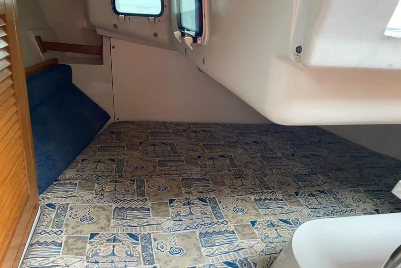 Slide: The Image of 1999 Catalina 28 MkII sailboat with navigation equipment, sailing on calm waters under a clear sky. - 8