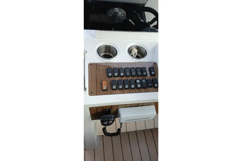 Slide: The Image of Control panel of 2014 Cruisers Yachts 41 Cantius with switches and cup holders. - 10