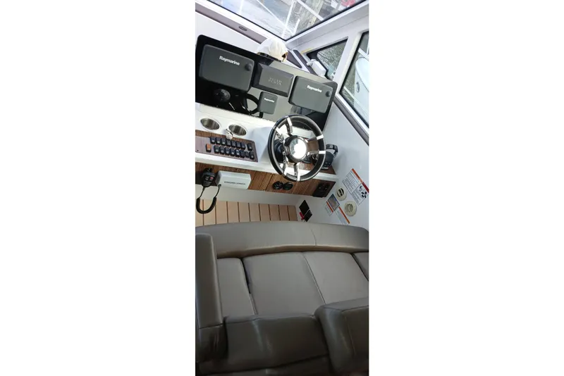 Slide: The Image of 2014 Cruisers Yachts 41 Cantius helm with steering wheel and navigation equipment. - 12