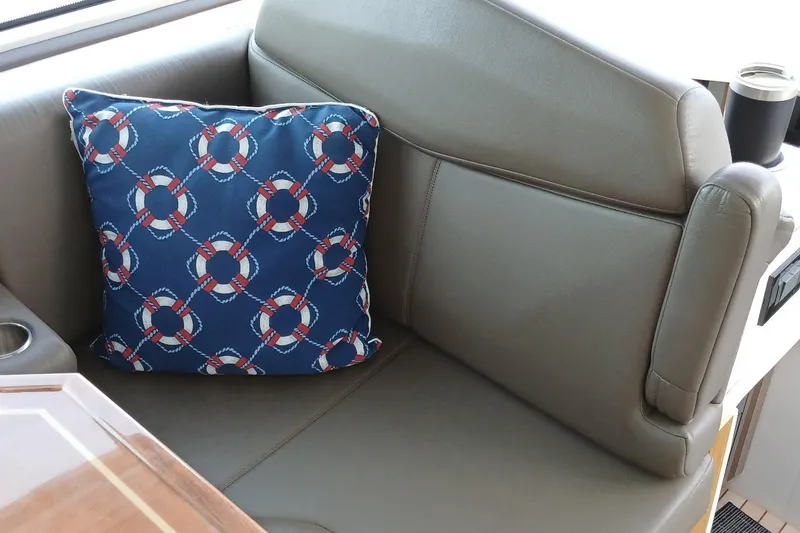 Slide: The Image of Leather seating with nautical-themed cushion on 2014 Cruisers Yachts 41 Cantius. - 15