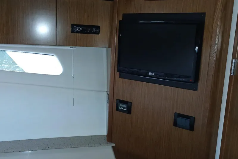 Slide: The Image of Interior of 2014 Cruisers Yachts 41 Cantius with TV and wooden paneling. - 22