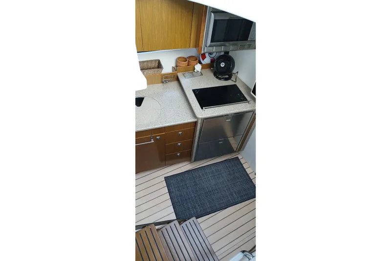 Slide: The Image of 2014 Cruisers Yachts 41 Cantius kitchen with modern appliances and wooden cabinetry. - 23