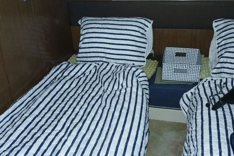Slide: The Image of Interior of 2014 Cruisers Yachts 41 Cantius with striped bedding and decorative basket. - 28