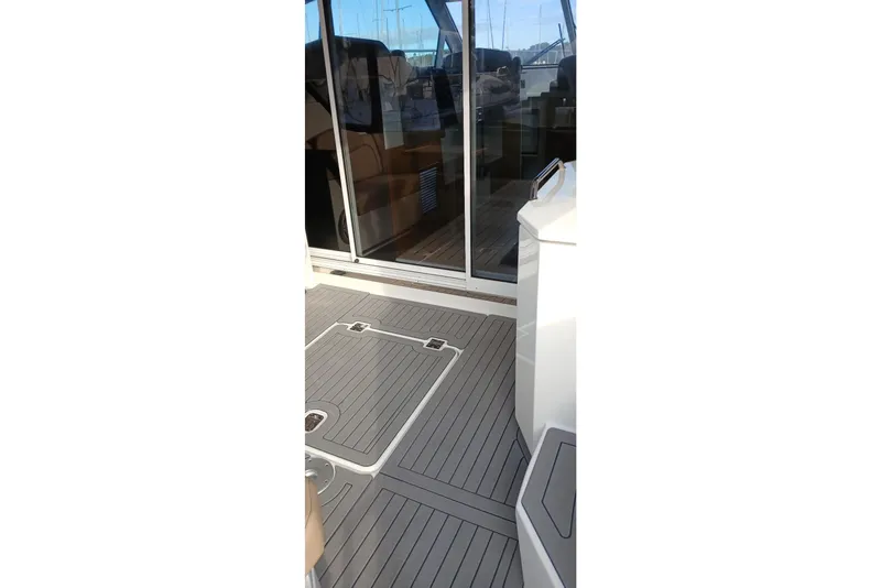 Slide: The Image of 2014 Cruisers Yachts 41 Cantius deck with sliding glass doors and sleek flooring. - 3