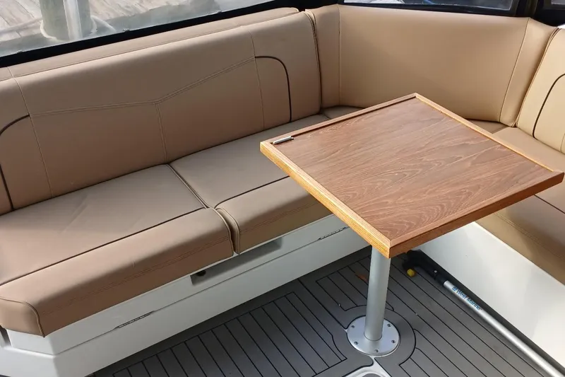 Slide: The Image of Luxurious seating area on 2014 Cruisers Yachts 41 Cantius with wooden table. - 4