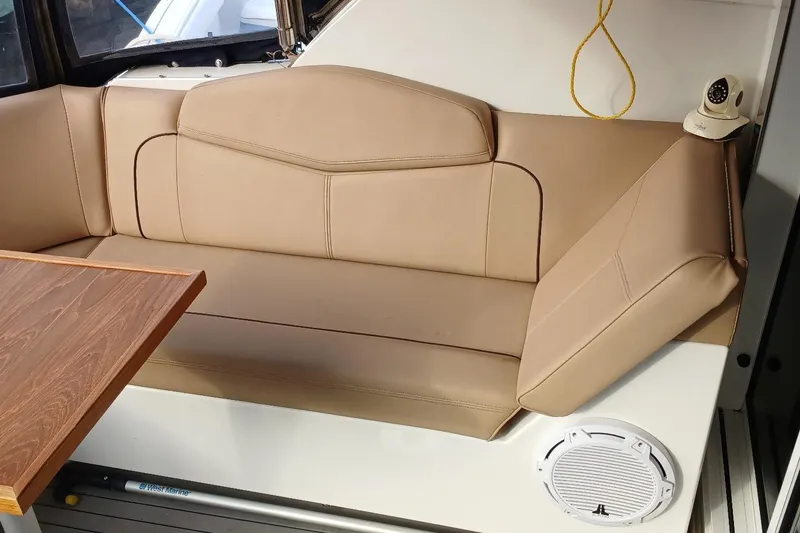 Slide: The Image of Luxurious beige seating area on 2014 Cruisers Yachts 41 Cantius with wooden table. - 5