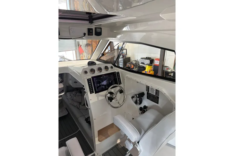 Slide: The Image of Interior of 2020 Protector 310 Targa boat with modern dashboard and steering wheel. - 1
