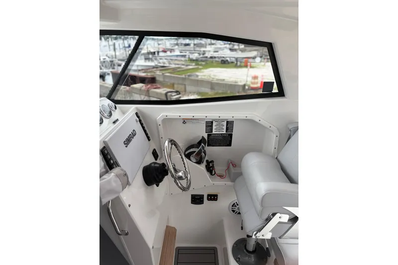 Slide: The Image of Interior of 2020 Protector 310 Targa boat with steering wheel and navigation equipment. - 12