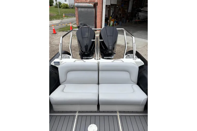 Slide: The Image of 2020 Protector 310 Targa boat with dual outboard engines and cushioned seating. - 15