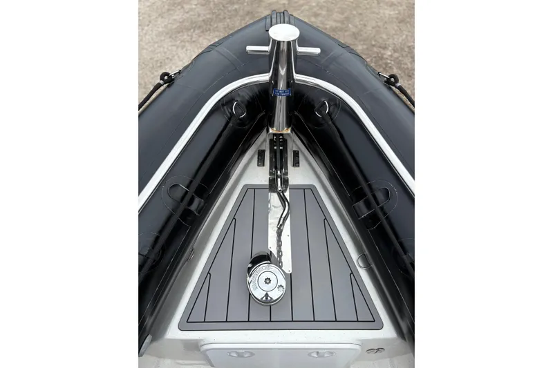 Slide: The Image of 2020 Protector 310 Targa boat bow with sleek black and gray design. - 20