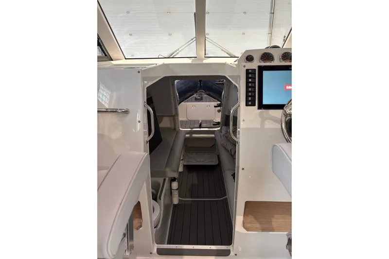 Slide: The Image of Interior view of 2020 Protector 310 Targa boat, featuring modern controls and seating. - 28