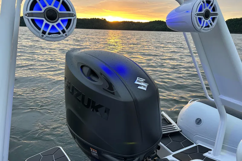 Slide: The Image of 2025 Highfield Sport 660 boat with Suzuki engine at sunset on a lake. - 12
